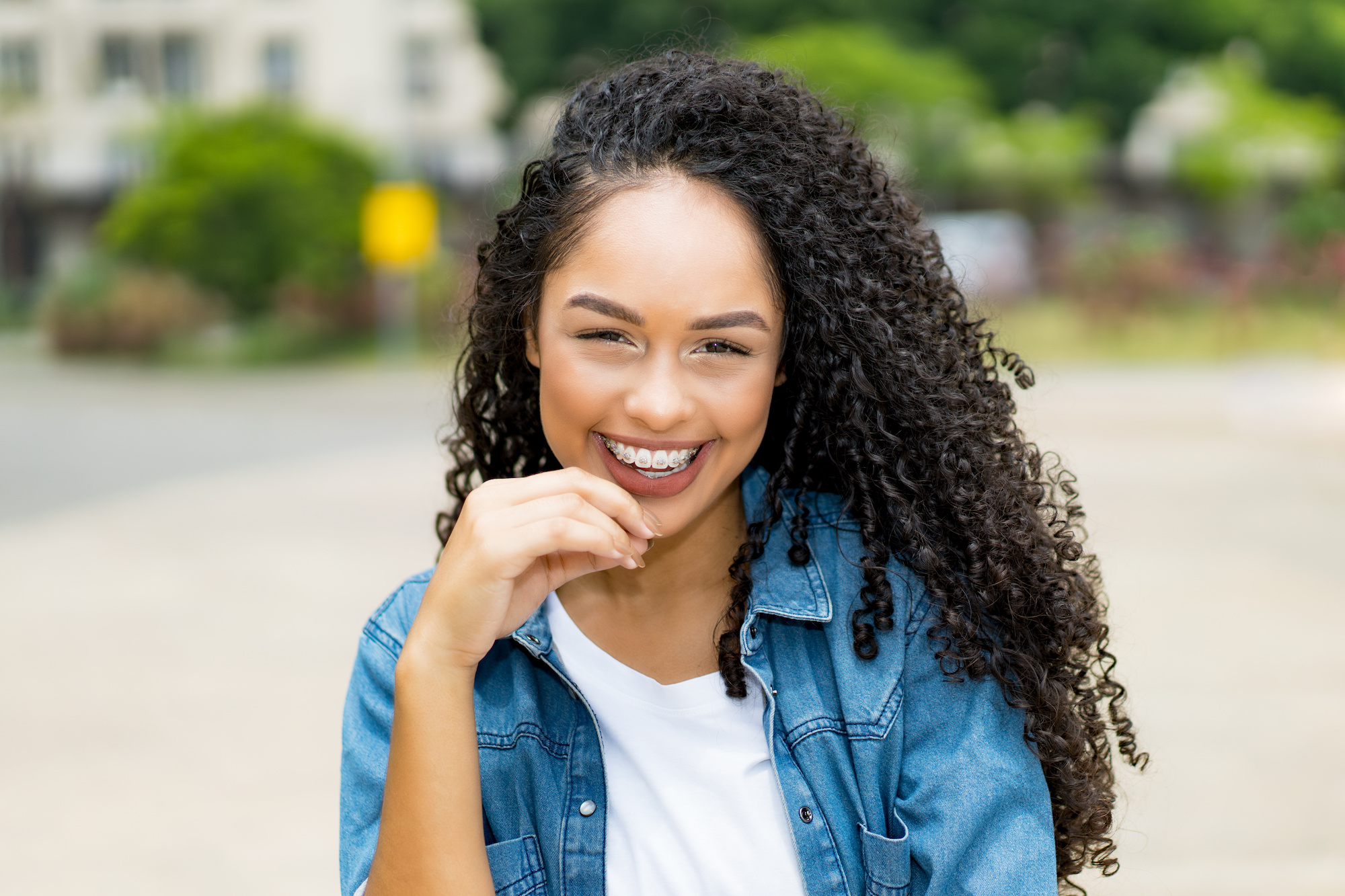 young woman with clear braces smiling